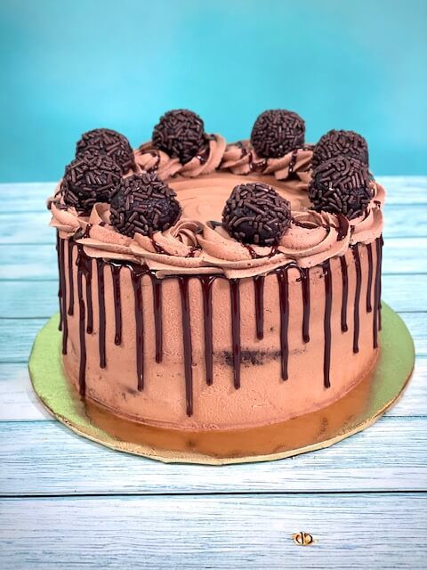 Triple Chocolate Ganache Layer Cake with ganache drip down the sides.