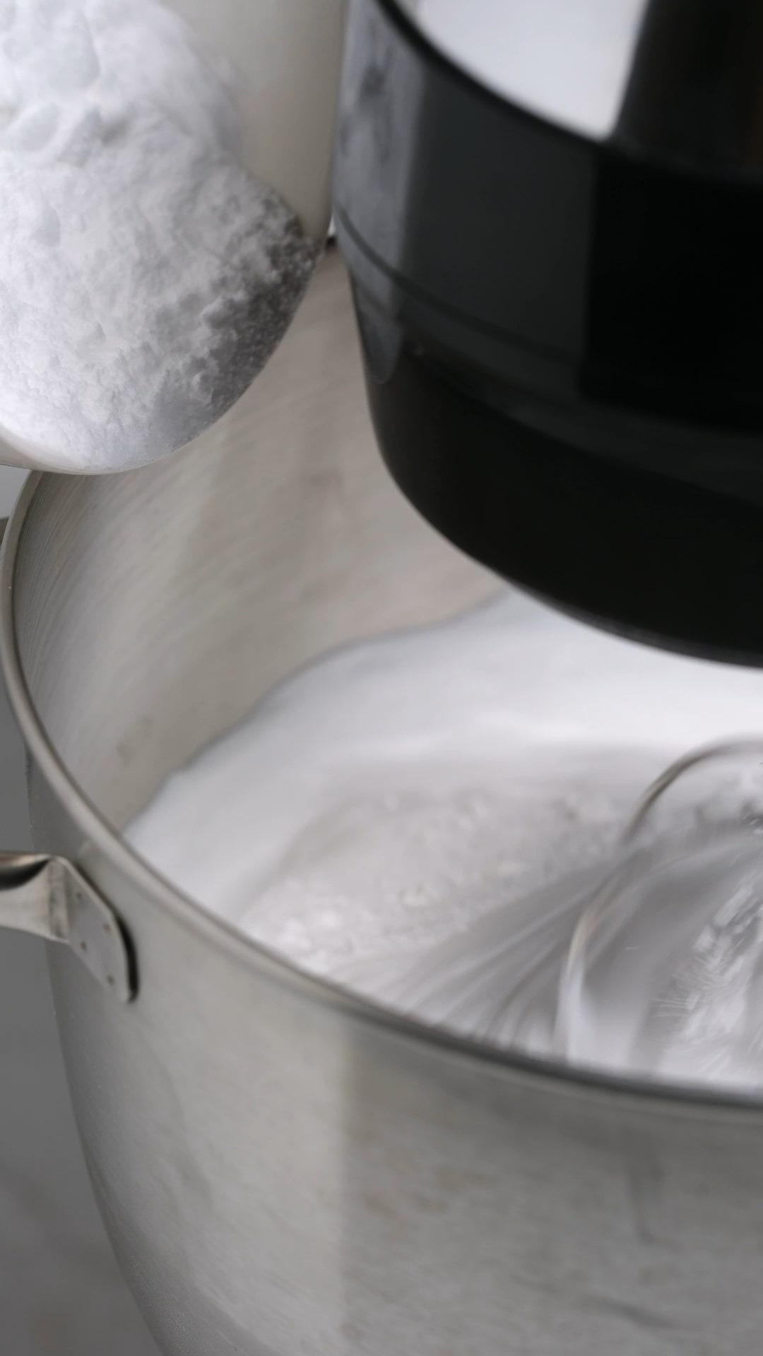 Instant Clear Jel and Powdered sugar being added to whipped cream. 