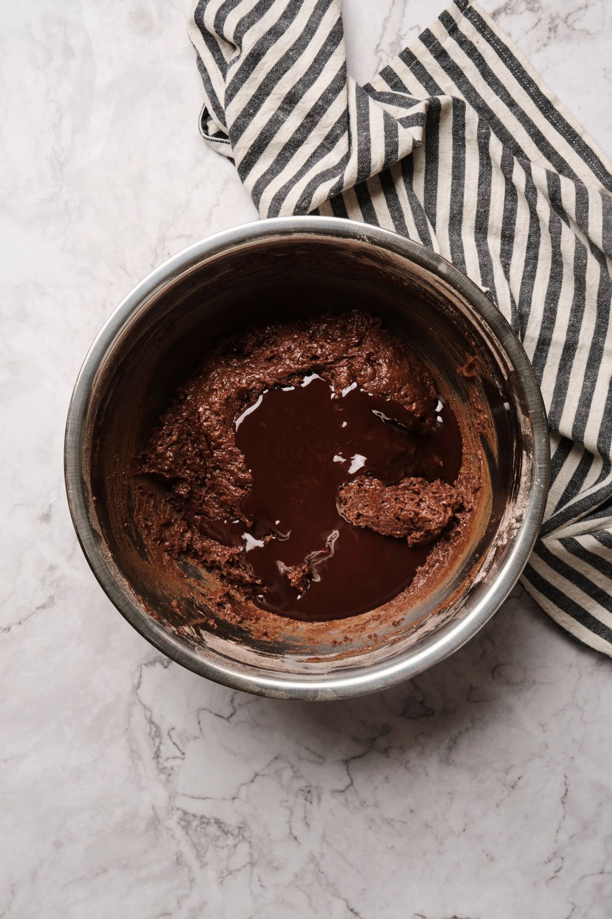 Chocolate ganache cake batter mixed in a bowl.
