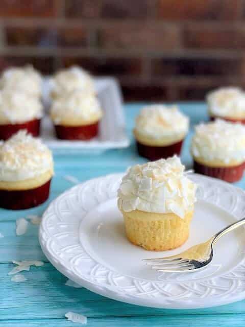 Coconut Cupcake with whipped cream frosting on a plate