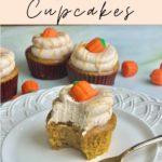 an image of a moist pumpkin cupcake with a bite taken out with a candy pumpkin on top and the text "extra moist pumpkin spice cupcakes, a bakery recipe, amycakesbakes.com"