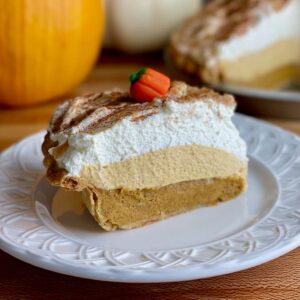 A slice of pumpkinc cream pie on a plate.