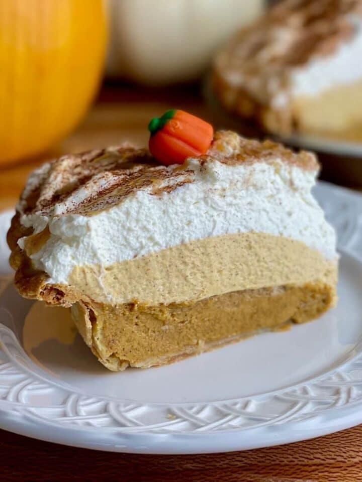 A slice of pumpkinc cream pie on a plate.