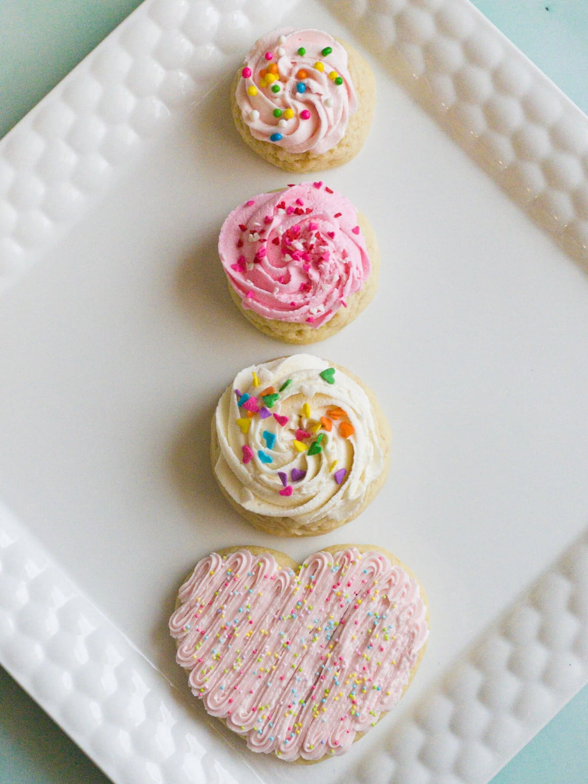 4 sizes of frosted sugar cookies--a 1 ounce cookie, 1.5 ounce cookie, 2 ounce cookie, and a shaped heart cookie