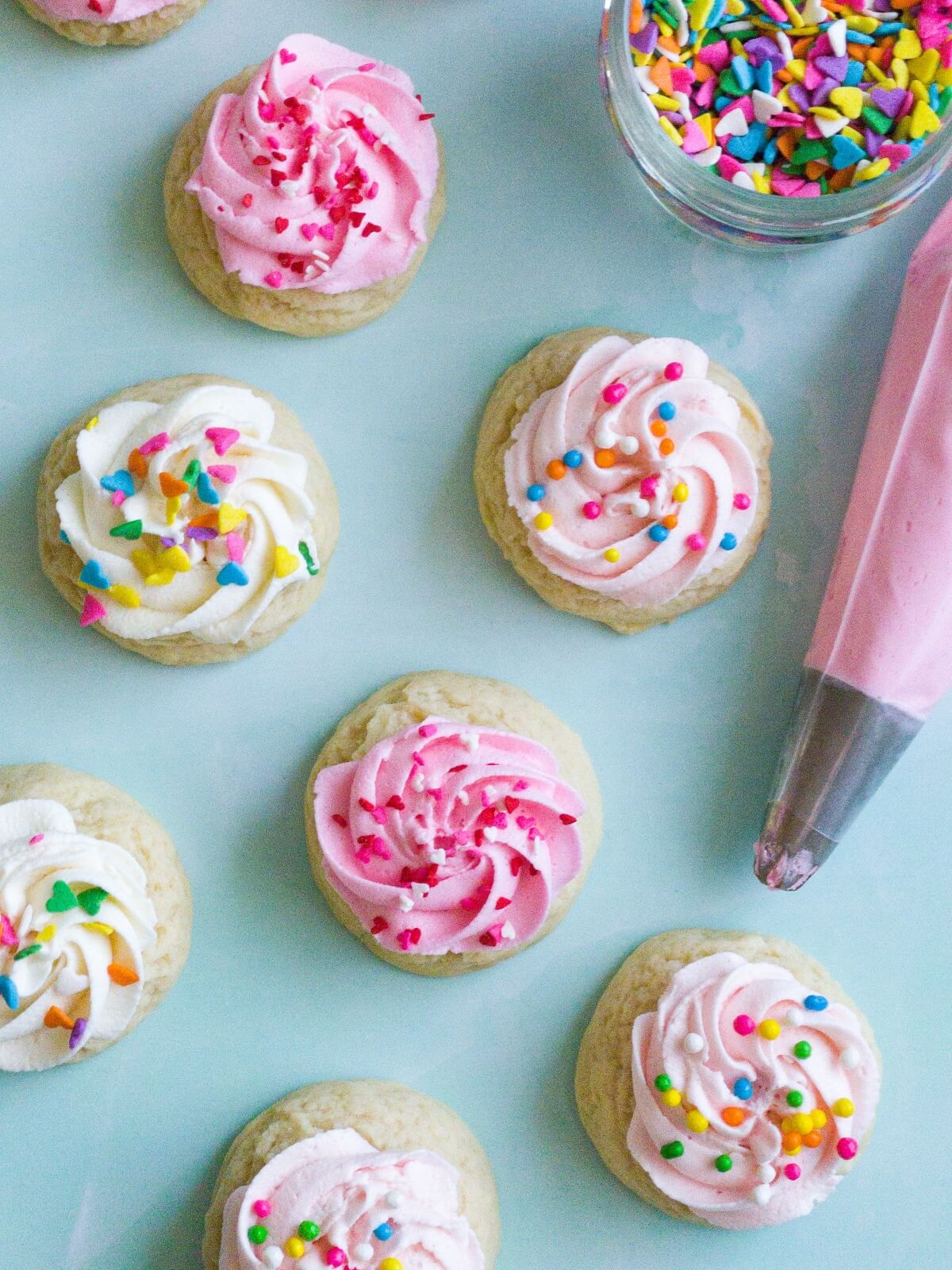frosted mini sugar cookies with shades of pink and white frosting
