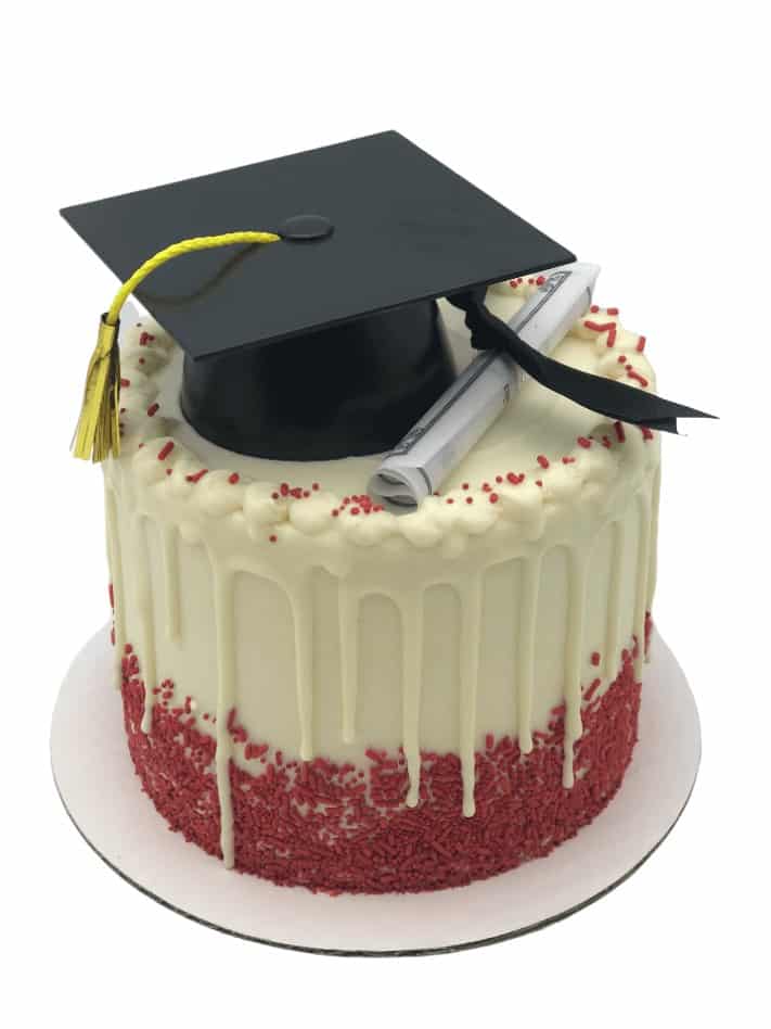 a graduation themed drip cake