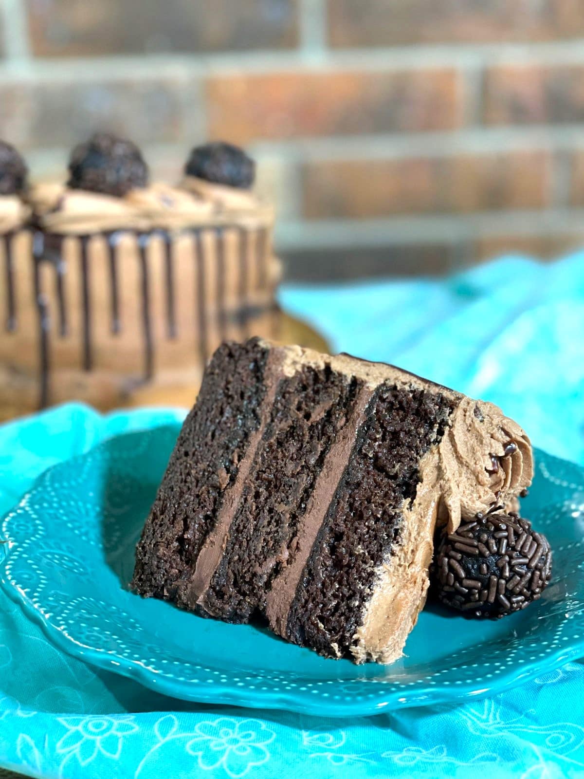 A slice of moist chocolate ganache cake