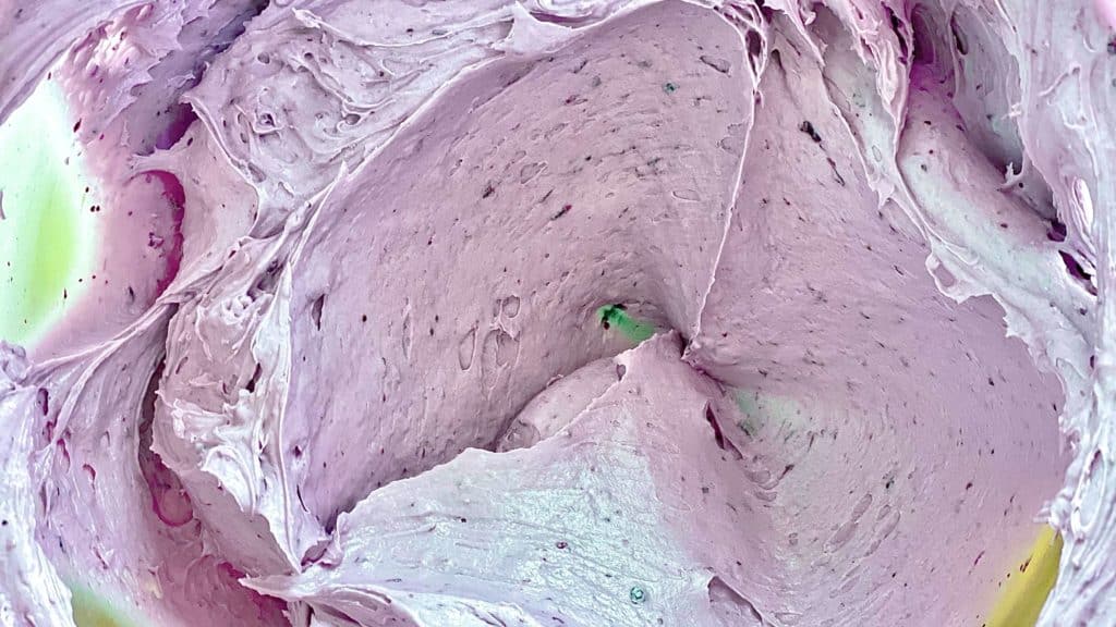 A closeup of blueberry buttercream frosting.