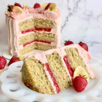 a slice of strawberry banana cake with the cut cake in the background