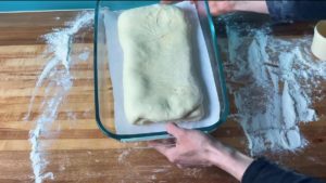 Folded up danish dough in a baking pan.