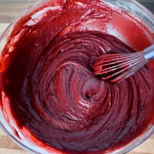 A bowl of thick red velvet cake batter