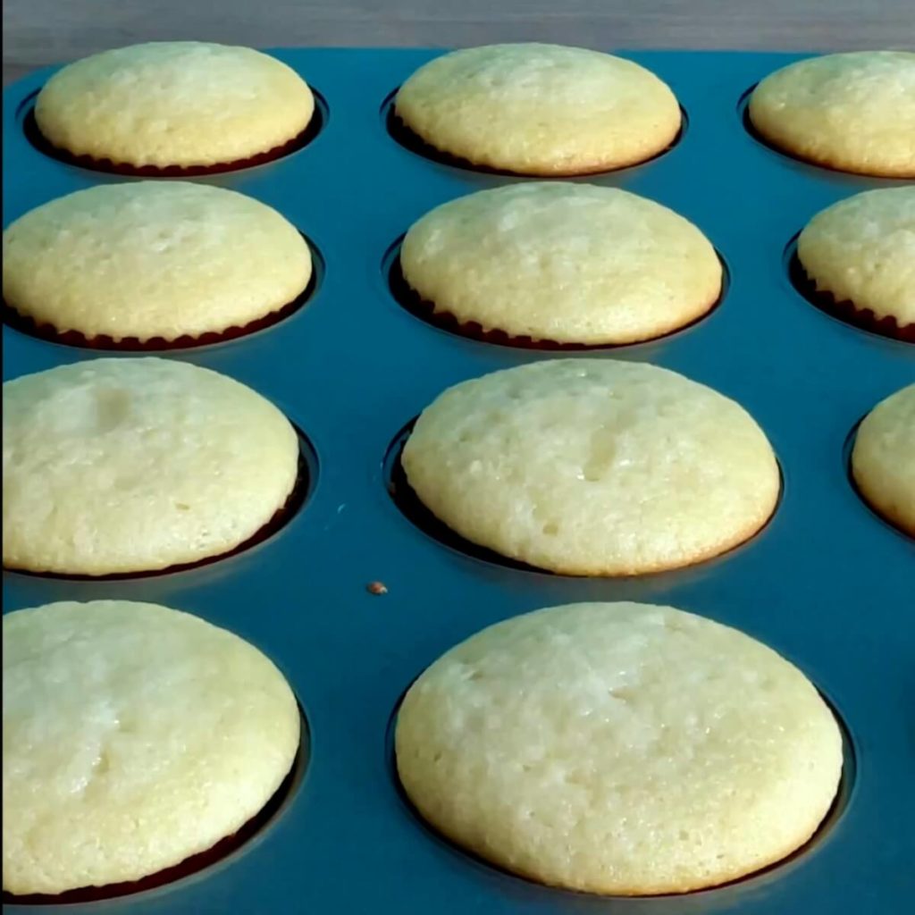 A closeup of moist yellow vanilla cupcakes with the reverse creaming method.