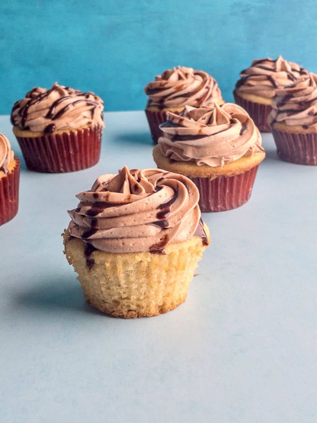 Moist vanilla cupcakes with swirls of nutella buttercream and chocolate drip