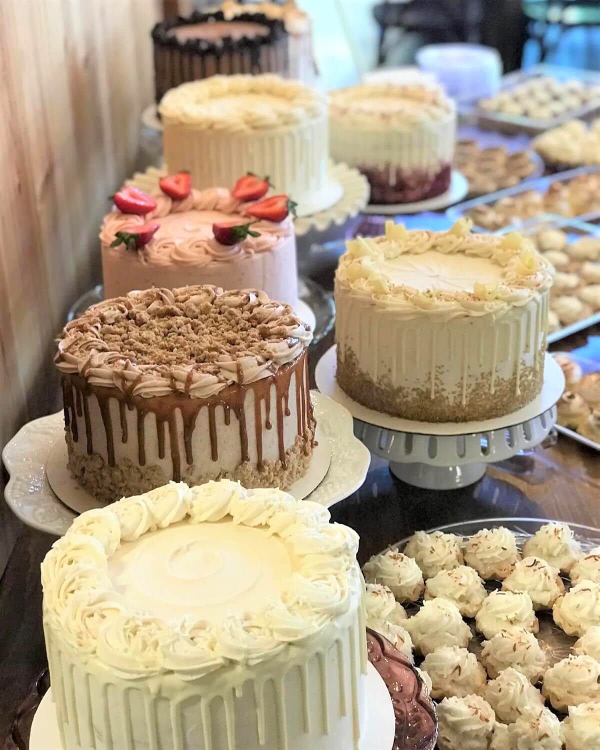 A dessert table filled with bakery-style cakes and pastries
