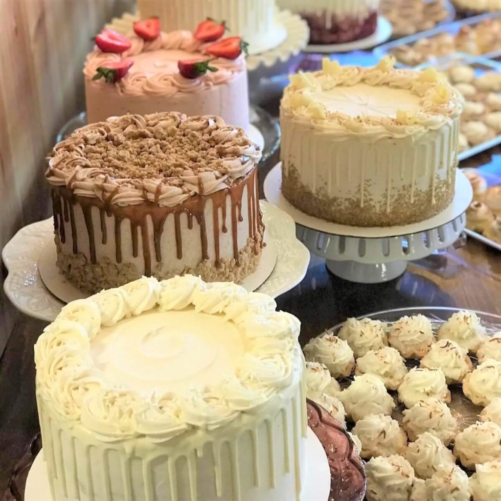 A dessert table filled with professional cakes and pastries