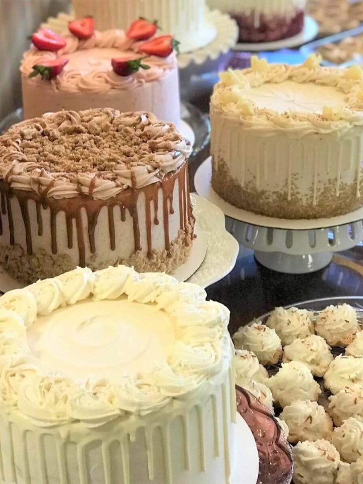 A dessert table filled with professional cakes and pastries