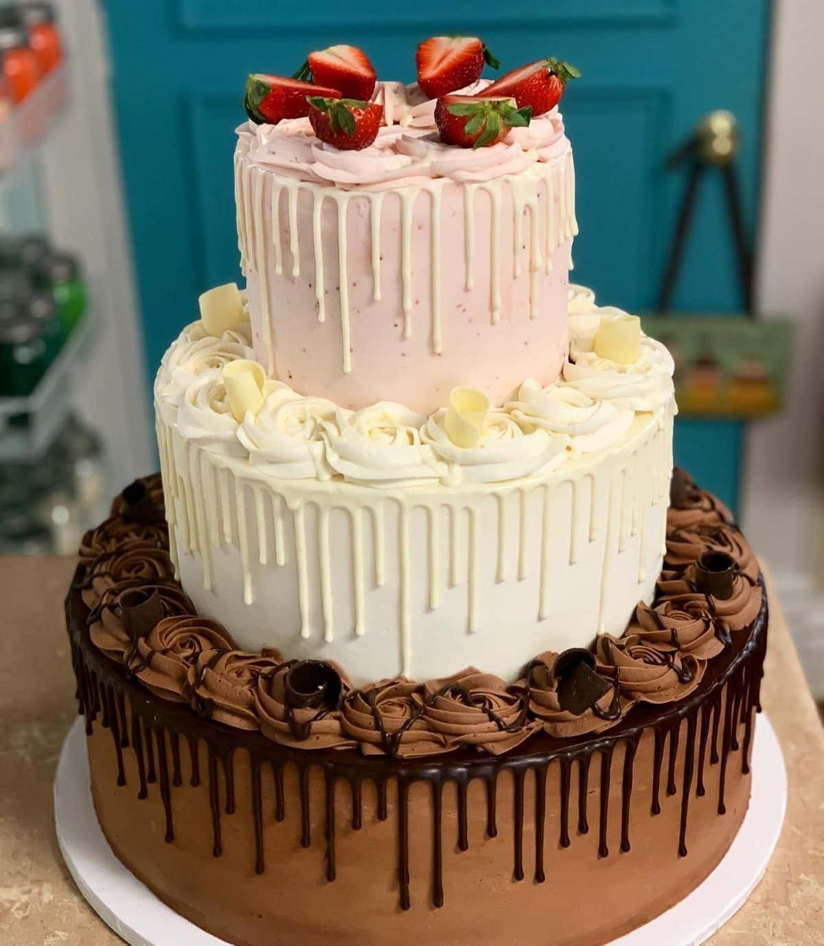 A tiered wedding cake at a bakery getting ready to be transported.