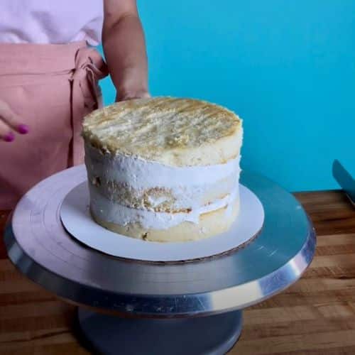 A filled cake with a thin crumb coat of buttercream.