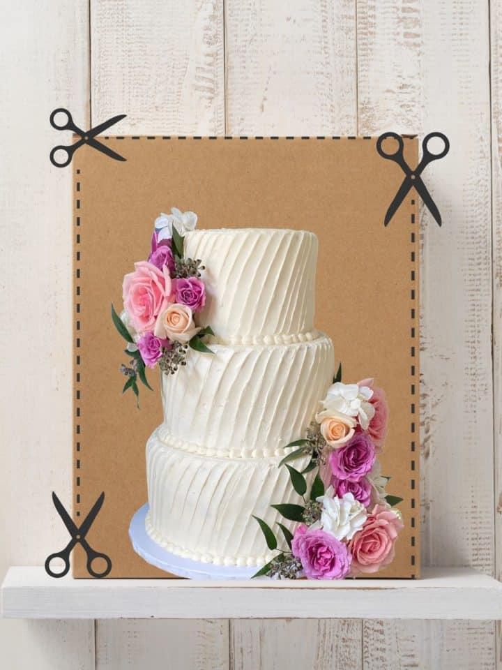 A tall cardboard box with scissors lines showing to cut along the front sides to create a door to place a tiered wedding cake, with an image of a wedding cake in front of it.