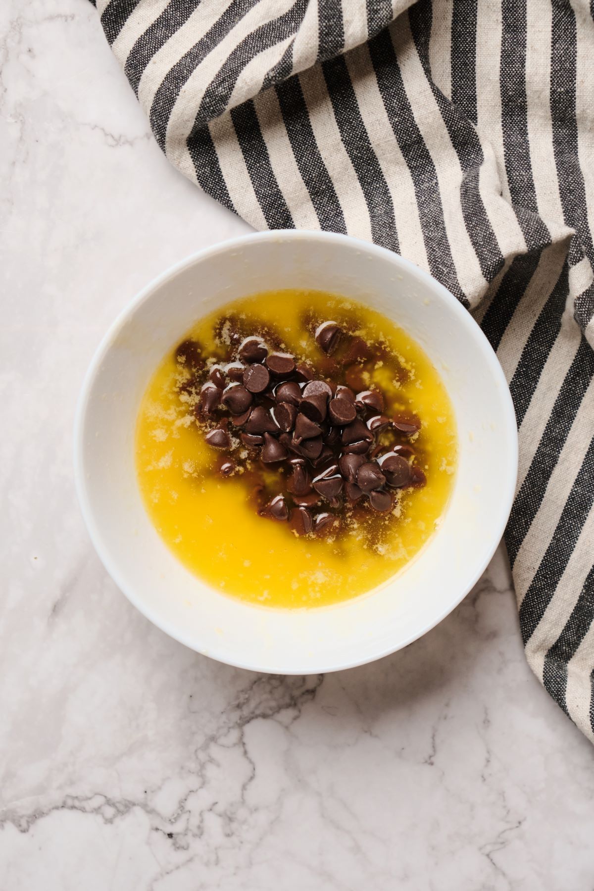 Chocolate chips in butter in a bowl.