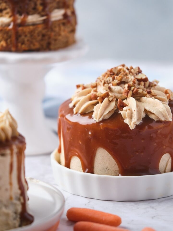 Decorated miniature carrot cakes with caramel drizzle and cinnamon buttercream.