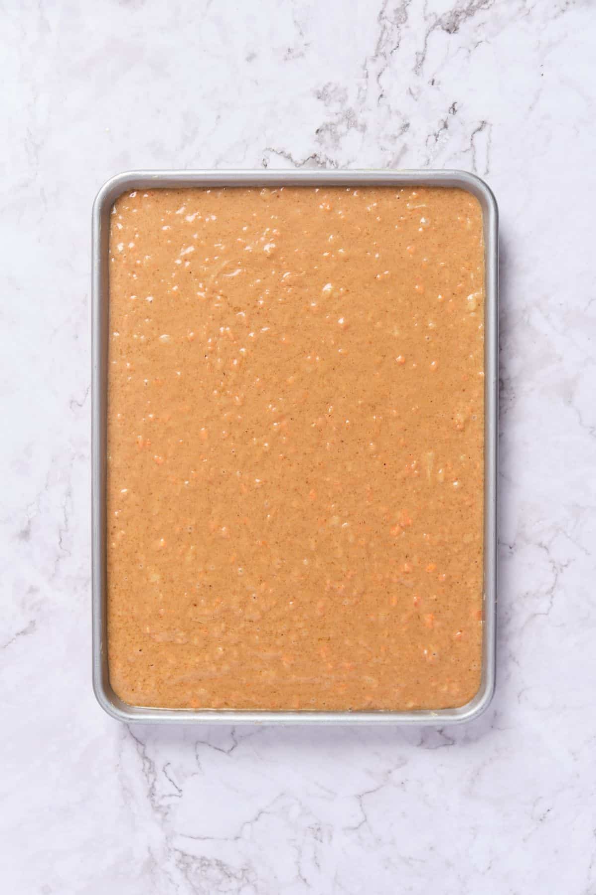 Carrot cake batter in the cake pan.