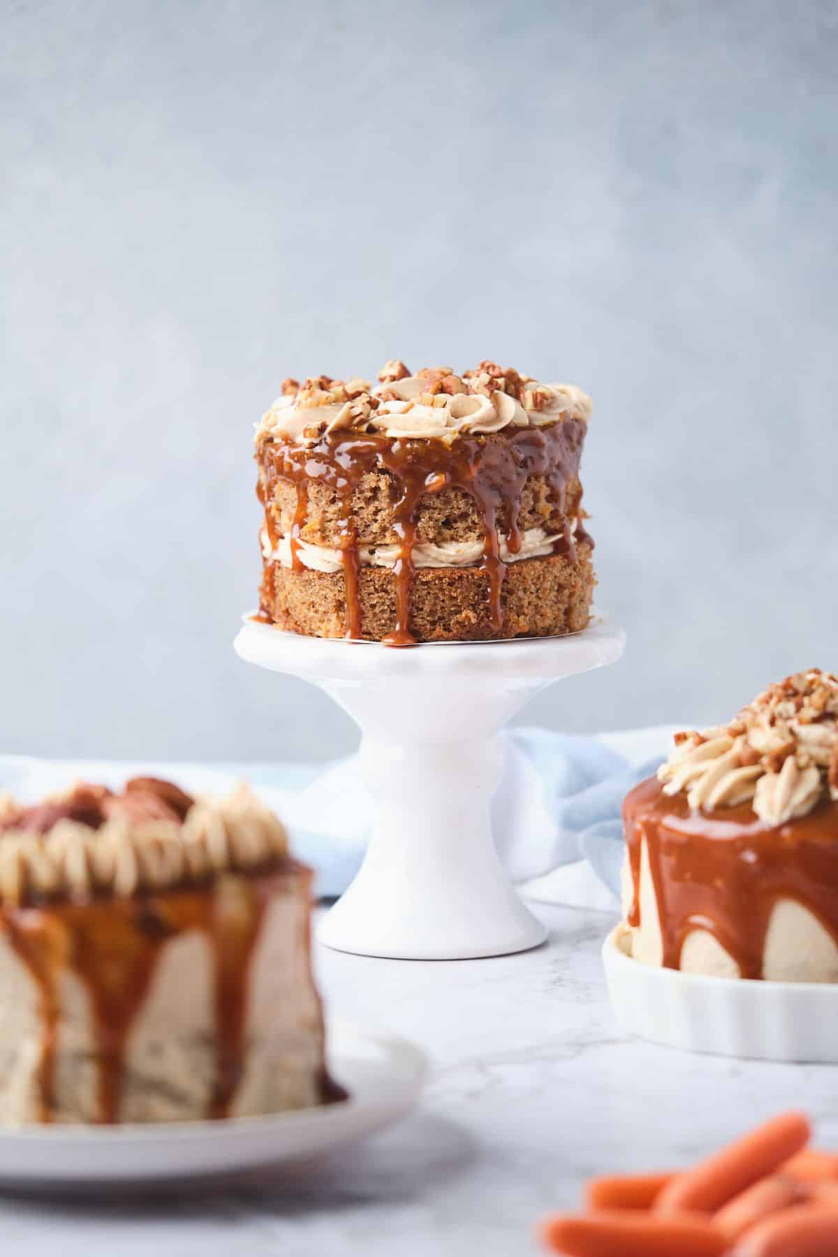 3 mini carrot cakes decorated with caramel drizzle and pecans.
