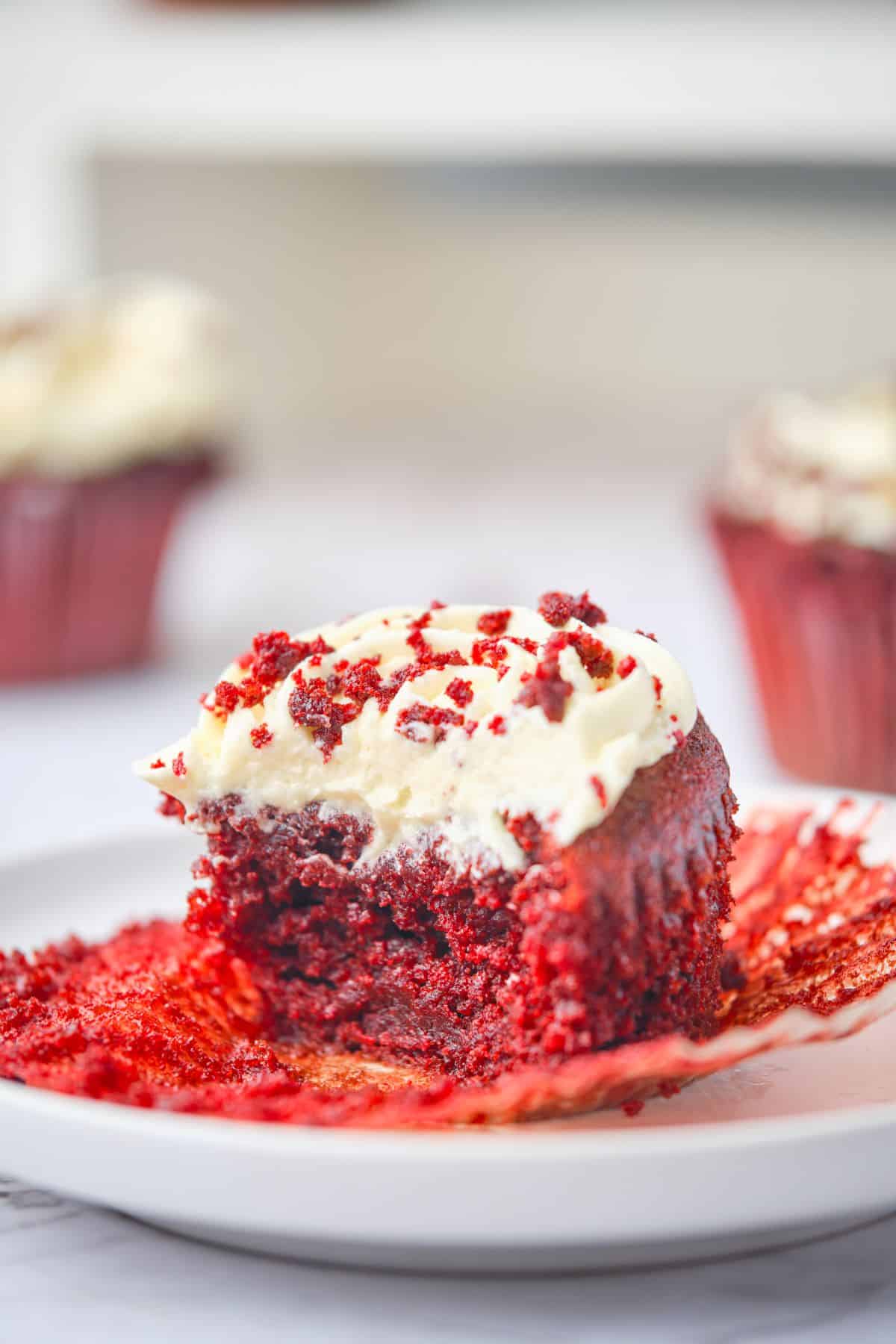 A red velvet cupcake cut open to show the soft inside.