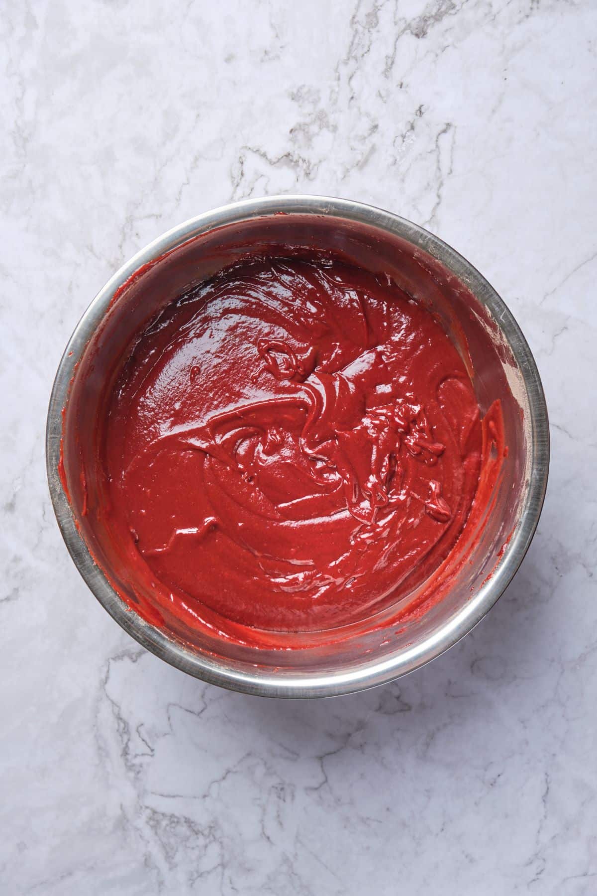 Red velvet cupcake batter in a bowl.