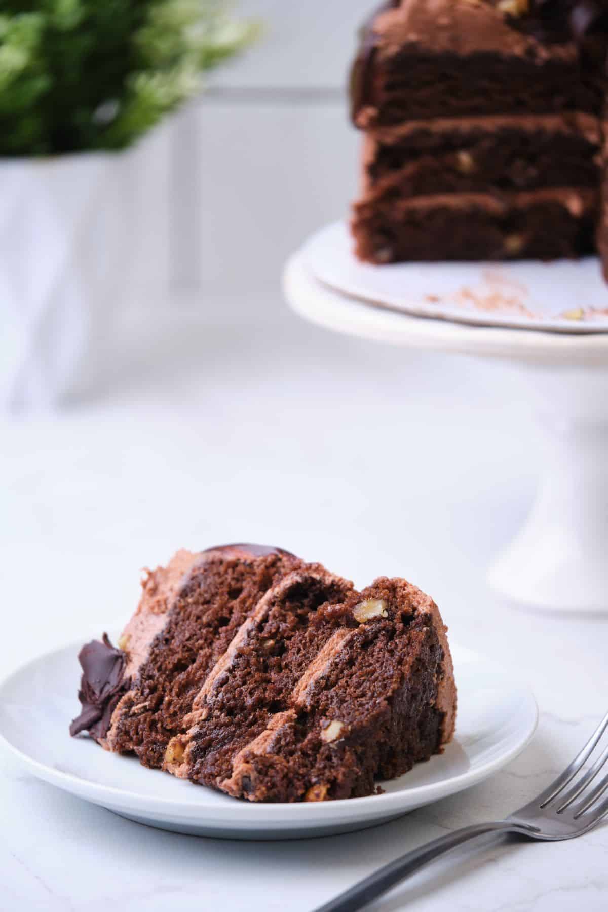 A slice of chocolate walnut cake on a plate.