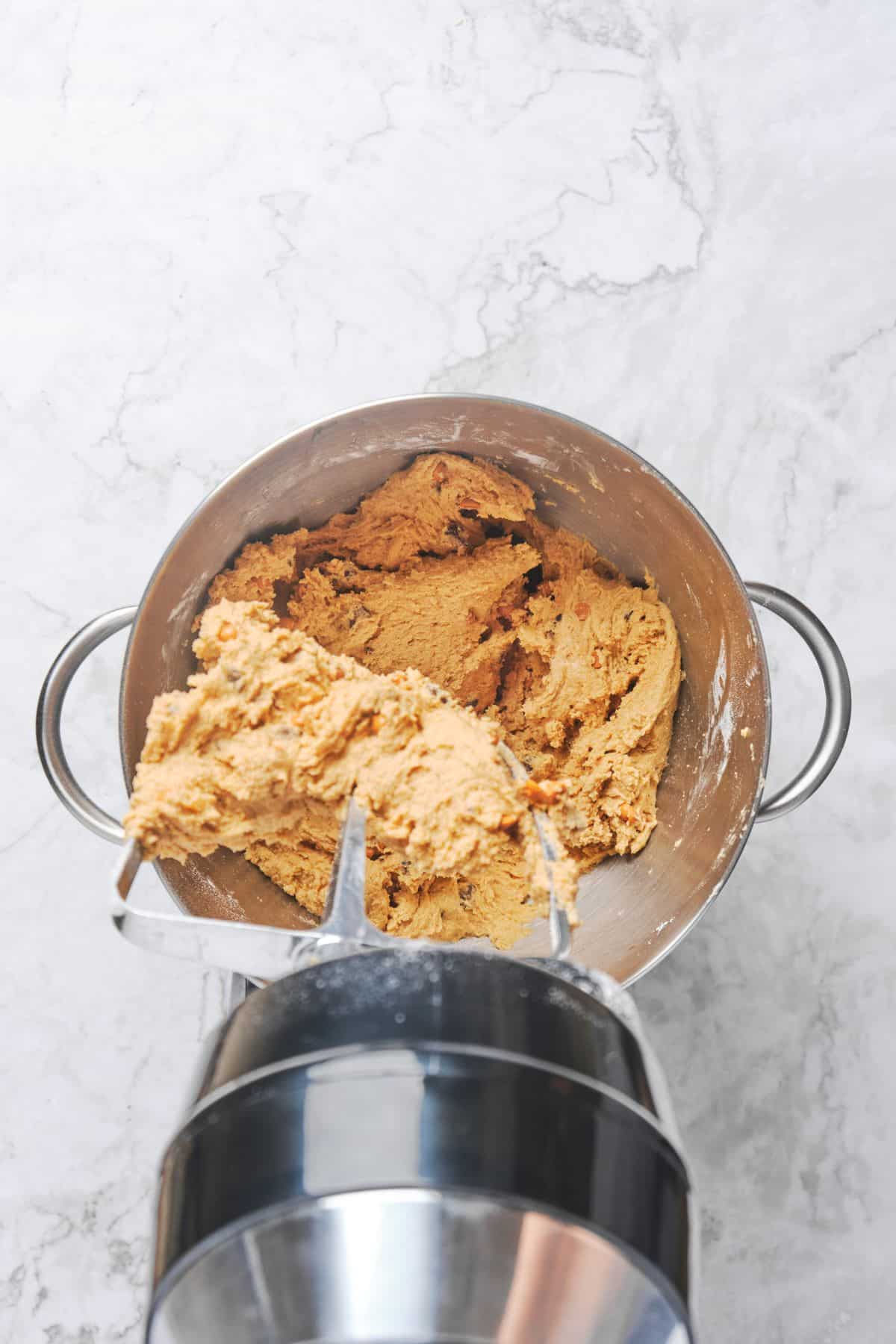 Butterscotch cookie dough that has just been blended before adding chocolate chips and butterscotch chips.