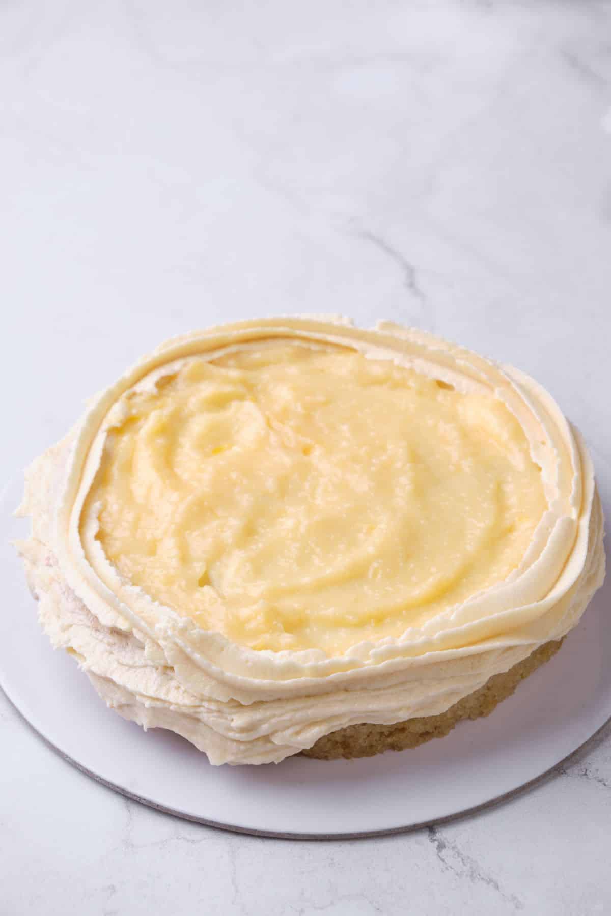 Lemon curd filling on top of a cake layer.