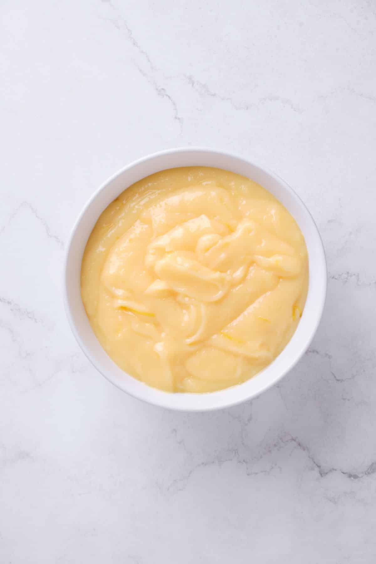 A bowl of homemade lemon curd filling.