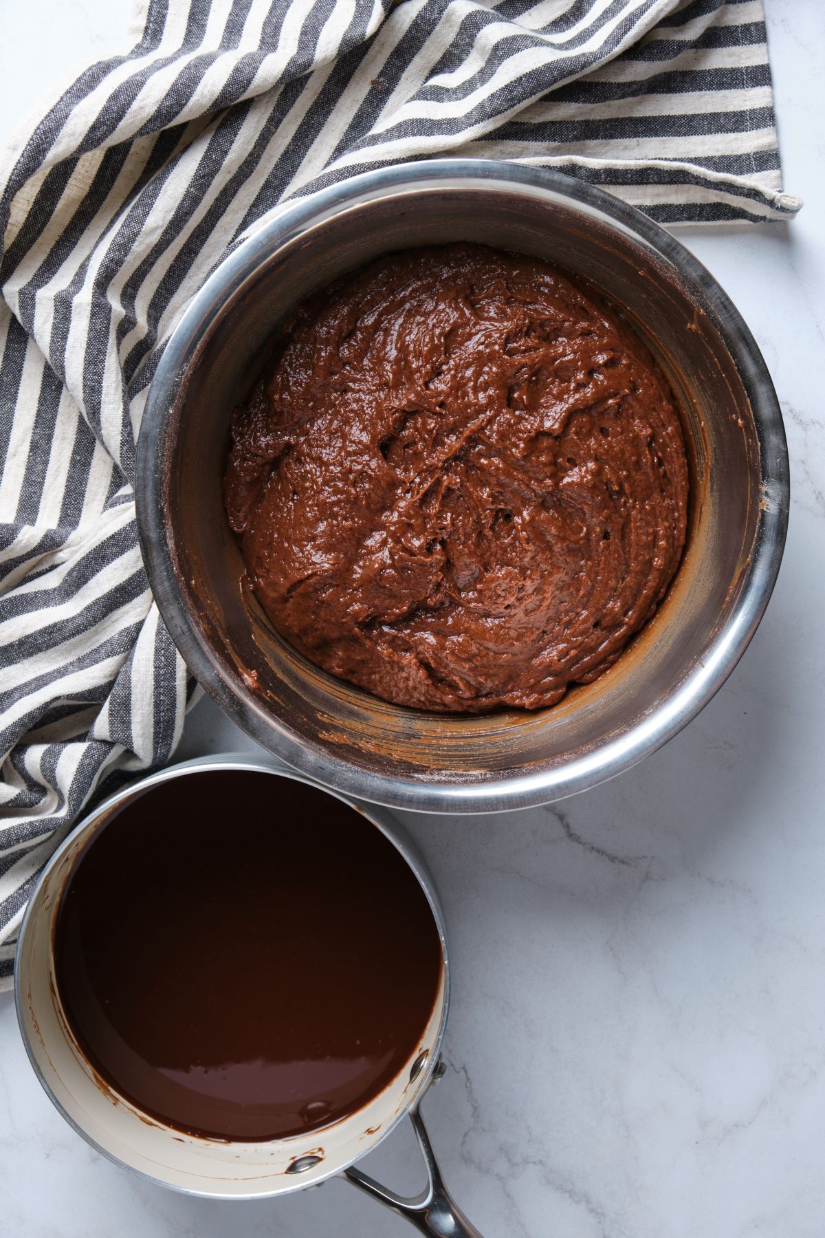 The chocolate fudge batter and the chocolate butter mixture in bowls.