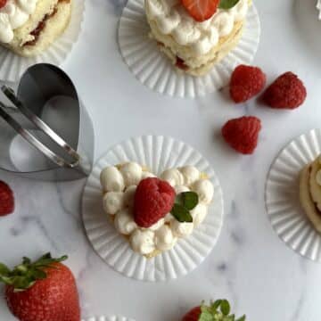 Mini heart cakes topped with fresh strawberries and raspberries.