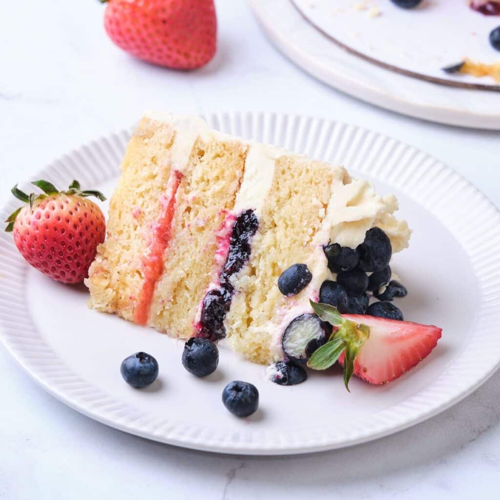 A vanilla cake made with the traditional creaming mixing method with strawberry and blueberry filling.