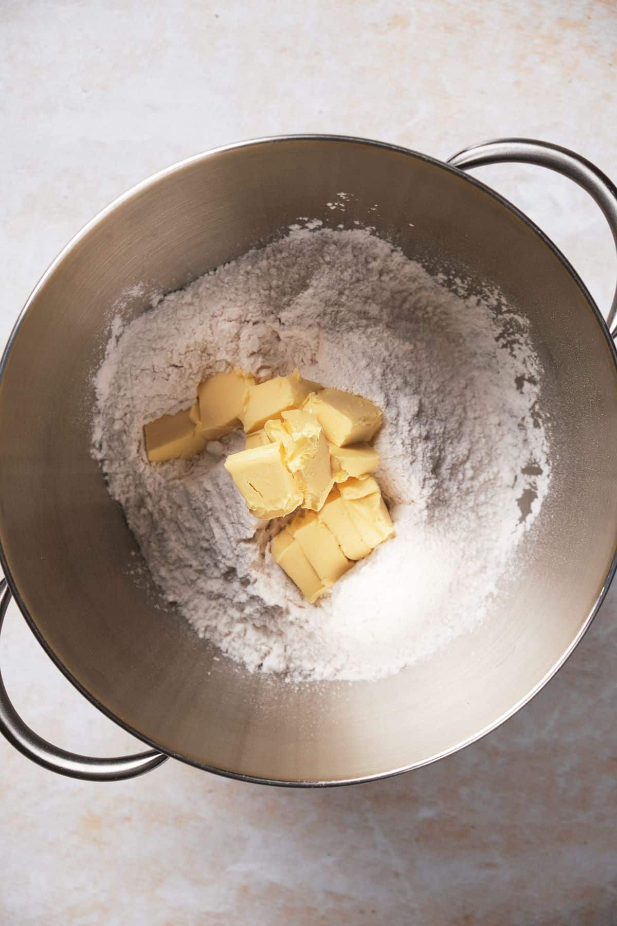 a mixing bowl with flour and softened butter.