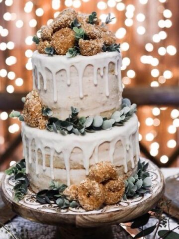 fall themed wedding cake with pumpkin cake and snickerdoodles, naked frosting, and a white chocolate ganache drip.