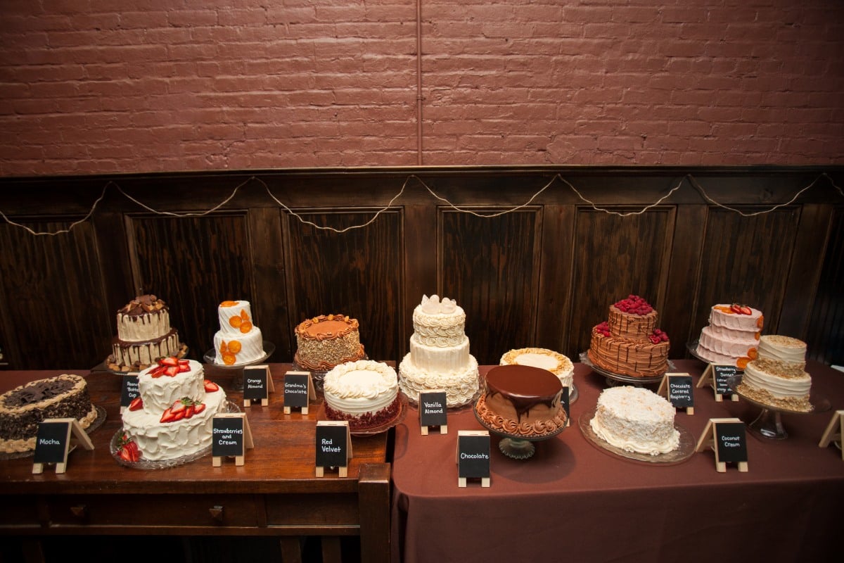 photo of 13 wedding cakes on display at a baker's wedding.