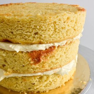 The orange almond cake has been layered with a thin layer of buttercream in between the three layers.