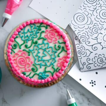 image of a decorated cake next to stencils to practice cake decorating.