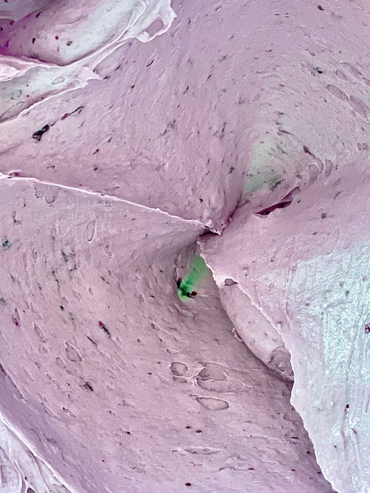 mixing bowl with creamy fresh blueberry buttercream made with blueberry puree and blueberry emulsion.