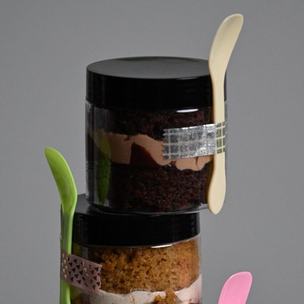 close up view of a cake in a jar with chocolate cake and chocolate frosting.