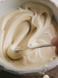 close up view of thick white chocolate ganache from the fridge.