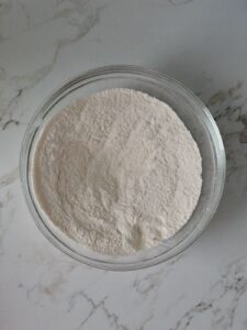 whisked dry ingredients in a glass bowl to make fresh raspberry layer cake.