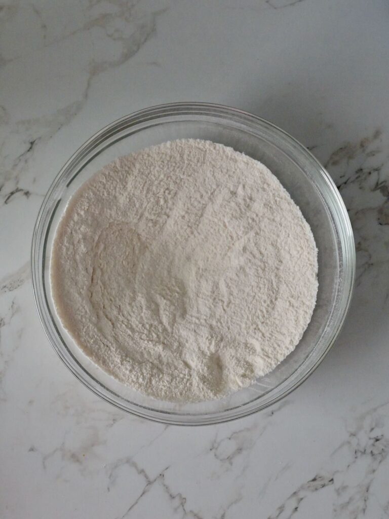 whisked dry ingredients in a glass bowl to make fresh raspberry layer cake.
