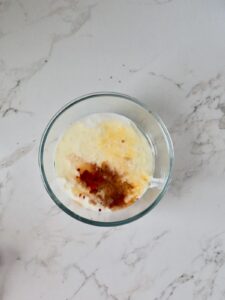 overhead view of a glass bowl with the wet ingredients to make raspberry cake.