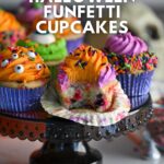 Colorful Halloween cupcakes with orange, purple and green frosting, halloween jimmy sprinkles and candy eyes, with the text "homemade halloween cupcakes" and "amycakesbakes.com"