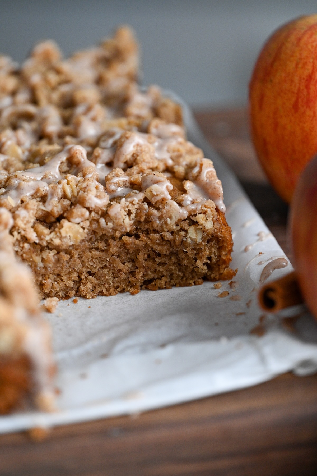 close up view of homemade applesauce coffee cake with a crumb topping made from oats and flour.