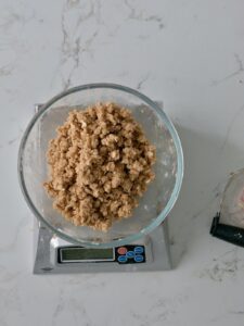 Moist Crumbs for the applesauce cake crumb topping in a bowl on a scale.